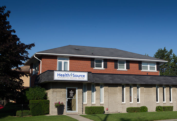 A wide shot of HealthSource Integrative Medical Centre on a sunny day with blue skies in Kitchener-Waterloo, Ontario