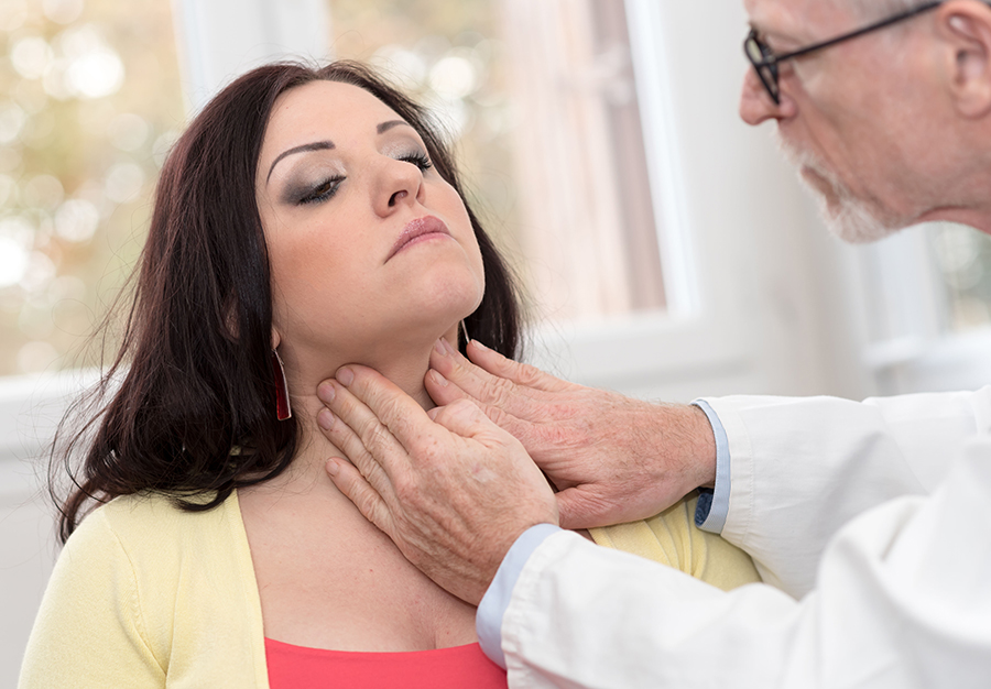 Doctor checking thyroid of a young patient