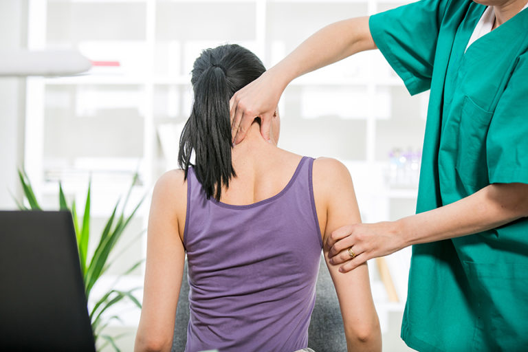 Chiropractor adjusting neck muscles