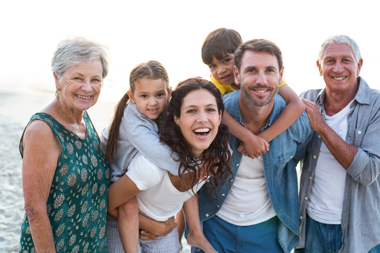 Happy family posing at the beach on a sunny day